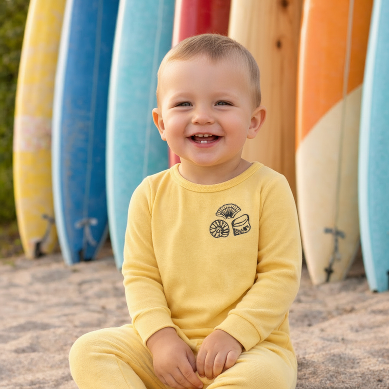 Boy in yellow footie without ring